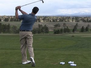 A person on the golf course implementing a swing change.